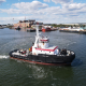 red and white tugboat on water